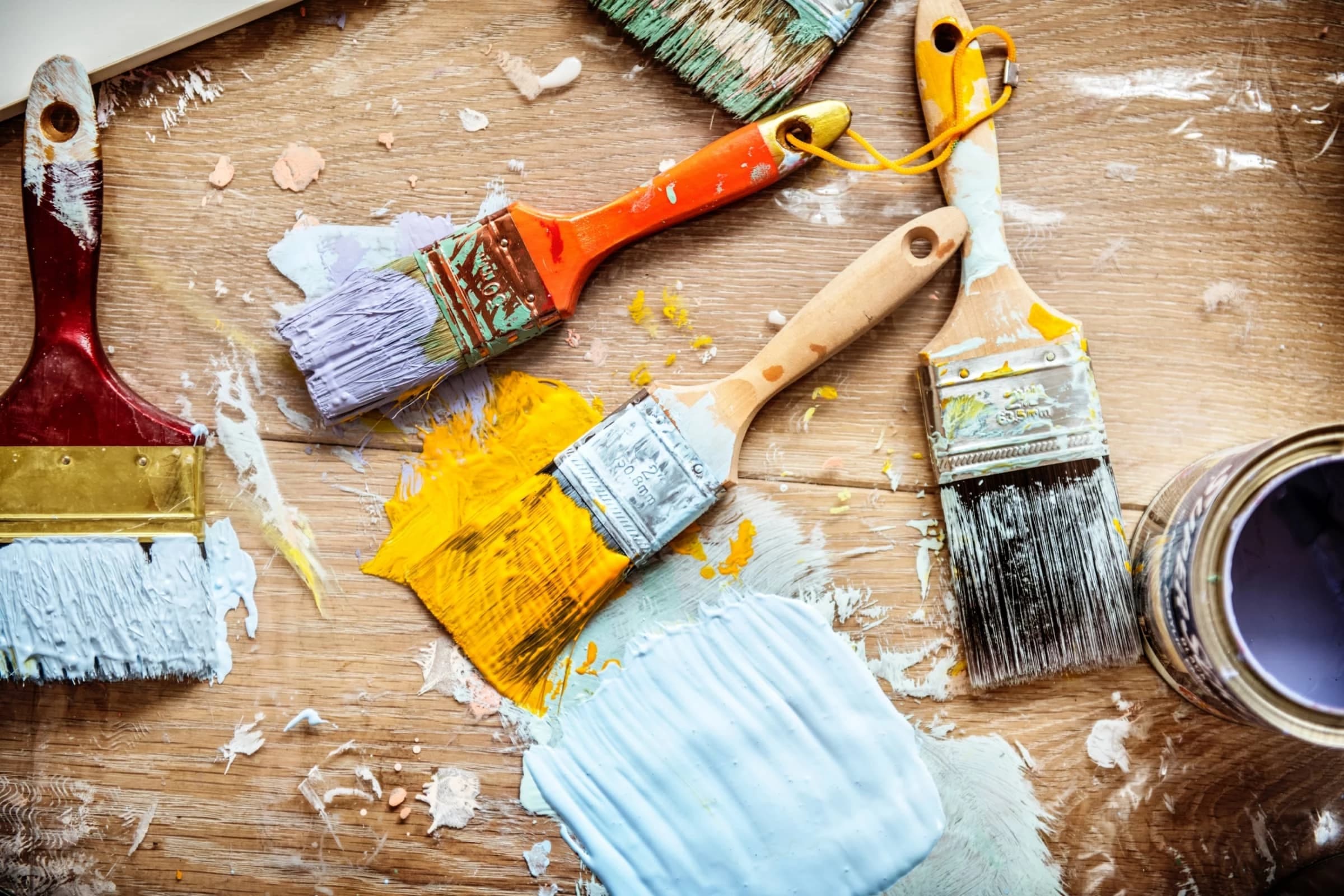Professional painter at work with brushes and premium paint